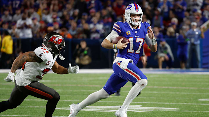 Buffalo Bills quarterback Josh Allen runs toward the sideline against Tampa Bay Buccaneers safety Antoine Winfield Jr. Buffalo Bills quarterback Josh Allen runs toward the sideline against Tampa Bay Buccaneers safety Antoine Winfield Jr.
