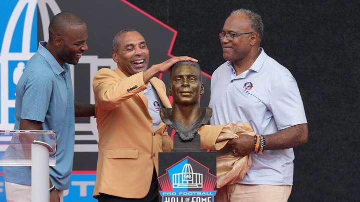 Aug 8, 2026; Canton, OH, USA; Pro Football Hall of Fame enshrinee Roger Craig presented by former teammate Jamie Williams and son Roderick Craig during the Class of 2026 enshrinement ceremony at Tom Benson Hall of Fame Stadium. Mandatory Credit: Kirby Lee-Imagn Images Aug 8, 2026; Canton, OH, USA; Pro Football Hall of Fame enshrinee Roger Craig presented by former teammate Jamie Williams and son Roderick Craig during the Class of 2026 enshrinement ceremony at Tom Benson Hall of Fame Stadium. Mandatory Credit: Kirby Lee-Imagn Images