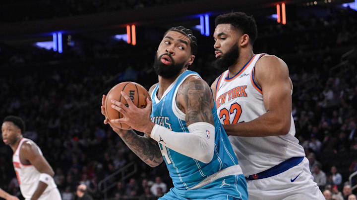 Dec 5, 2024; New York, New York, USA; Charlotte Hornets center Nick Richards (4) posts up against New York Knicks center Karl-Anthony Towns (32) during the first half at Madison Square Garden. Mandatory Credit: John Jones-Imagn Images