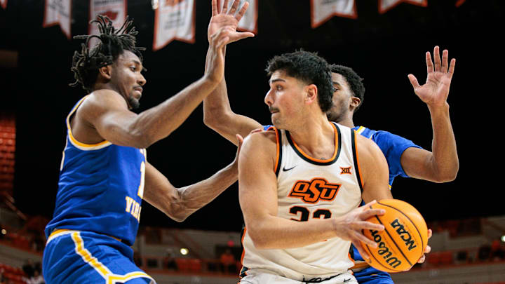 Feb 24, 2026; Stillwater, Oklahoma, USA; Oklahoma State Cowboys forward Parsa Fallah (22) protects the ball during the first half against the West Virginia Mountaineers at Gallagher-Iba Arena. Mandatory Credit: William Purnell-Imagn Images
