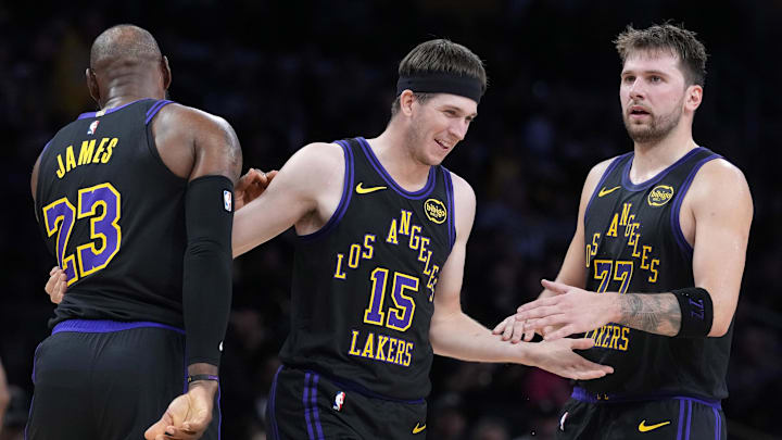Nov 18, 2025; Los Angeles, California, USA; Los Angeles Lakers guard Austin Reaves (15) is congratulated by forward LeBron James (23) and guard Luka Doncic (77) after a three-point basket in the second quarter at Crypto.com Arena. Mandatory Credit: Kirby Lee-Imagn Images