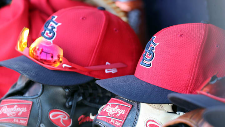 Mar 6, 2019; Tampa, FL, USA; St. Louis Cardinals hat and gloves lay in the dugout at George M. Steinbrenner Field. Mandatory Credit: Kim Klement-Imagn Images