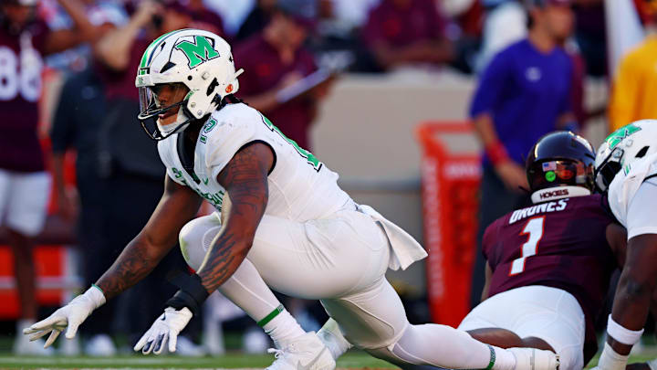 Sep 7, 2024; Blacksburg, Virginia, USA; Marshall Thundering Herd defensive lineman Mike Green (15) celebrates after sacking Virginia Tech Hokies quarterback Kyron Drones (1) during the first quarter at Lane Stadium. Mandatory Credit: Peter Casey-Imagn Images