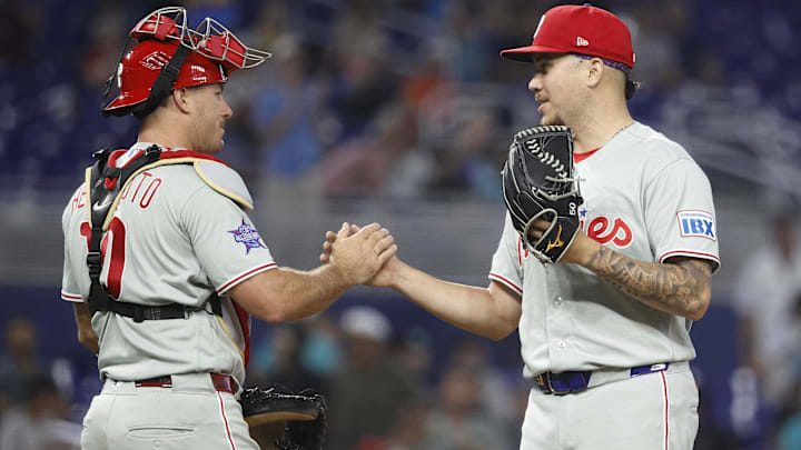 May 3, 2026; Miami, Florida, USA; Philadelphia Phillies catcher J.T. Realmuto (10) and relief pitcher Orion Kerkering (50) celebrate their win against the Miami Marlins following the game at loanDepot Park.