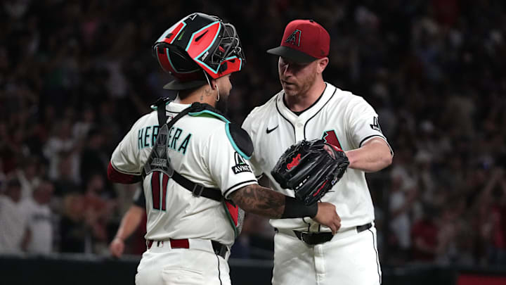 Jul 19, 2025; Phoenix, Arizona, USA; Arizona Diamondbacks catcher Jose Herrera (11) and pitcher Anthony DeSclafani (21) celebrates after defeating the St. Louis Cardinals at Chase Field. Mandatory Credit: Rick Scuteri-Imagn Images