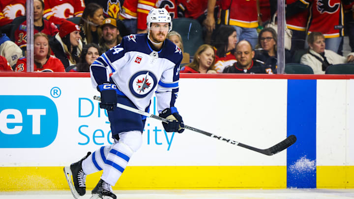 Oct 26, 2024; Calgary, Alberta, CAN; Winnipeg Jets defenseman Dylan Samberg (54) skates against the Calgary Flames during the third period at Scotiabank Saddledome. Mandatory Credit: Sergei Belski-Imagn Images