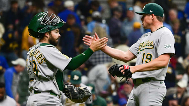 Apr 19, 2025; Milwaukee, Wisconsin, USA; Athletics pitcher Mason Miller (19) celebrates with catcher Shea Langeliers (23) after picking up a save against the Milwaukee Brewers at American Family Field. Mandatory Credit: Benny Sieu-Imagn Images
