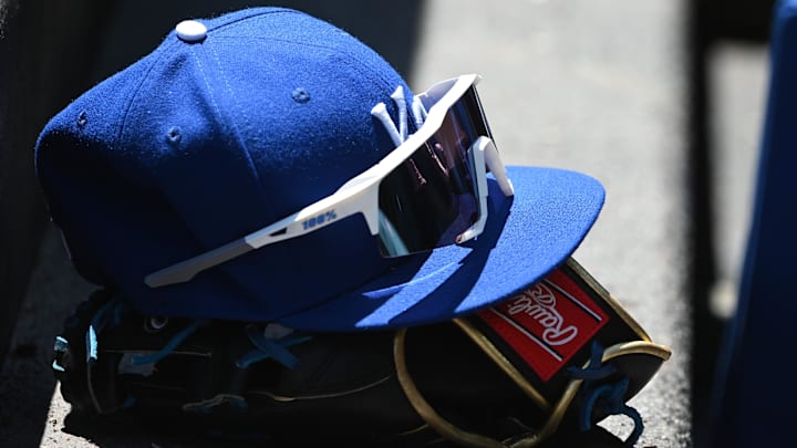 May 9, 2022; Baltimore, Maryland, USA;  A detailed view of Kansas City Royals hat and glove in the dugout during the first inning against the Baltimore Orioles at Oriole Park at Camden Yards. Mandatory Credit: Tommy Gilligan-Imagn Images