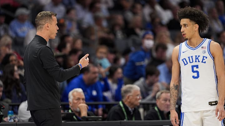 Mar 14, 2025; Charlotte, NC, USA; Duke basketball head coach Jon Scheyer talks with guard Tyrese Proctor (5) during a free throw  during the first half against the North Carolina Tar Heels at Spectrum Center.