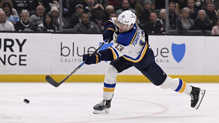 Mar 5, 2025; Los Angeles, California, USA;  St. Louis Blues right wing Alexey Toropchenko (13) takes a shot against the Los Angeles Kings during the third period at Crypto.com Arena. Mandatory Credit: Alex Gallardo-Imagn Images