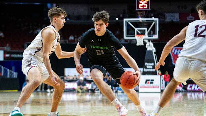 Grand View Christian's Brayden Hoben (21) drives down the court against Western Christian's Karsten Moret (2) on Thursday, March 13, 2025, at Wells Fargo Arena in Des Moines.