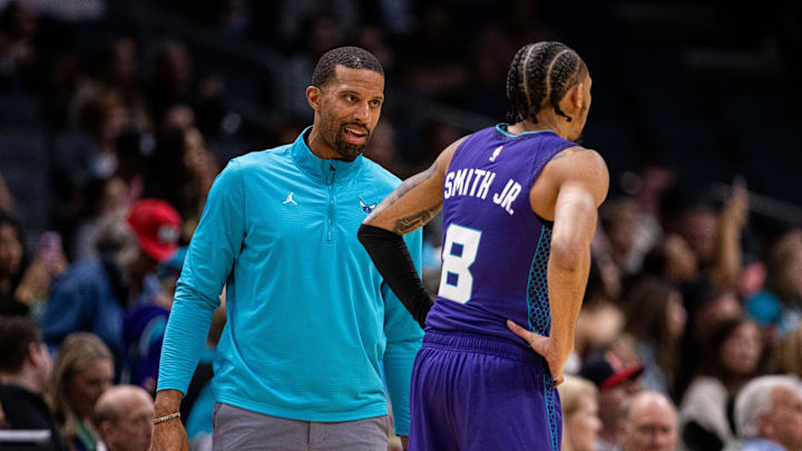 Mar 1, 2025; Charlotte, North Carolina, USA; Charlotte Hornets head coach Charles Lee talks to guard Nick Smith Jr. (8) during the first quarter against the Washington Wizards at Spectrum Center. Mandatory Credit: Scott Kinser-Imagn Images