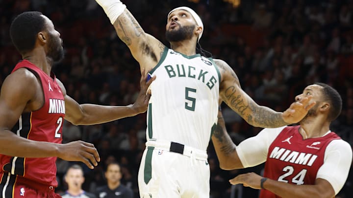 Nov 26, 2025; Miami, Florida, USA; Milwaukee Bucks guard Gary Trent Jr. (5) loses control of the ball between Miami Heat forward Andrew Wiggins (22) and guard Norman Powell (24) during the first half of an NBA Cup game at Kaseya Center. Mandatory Credit: Rhona Wise-Imagn Images