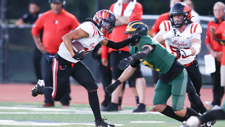 Clayton Valley WR fends off a San Ramon Valley defender. Clayton Valley WR fends off a San Ramon Valley defender.