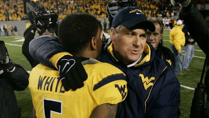 Nov 8, 2007; Morgantown, WV, USA;  West Virginia Mountaineers head coach Rich Rodriguez (right) hugs quarterback Patrick White (5) after defeating the Louisville Cardinals 38-31 at Milan Puskar Stadium in Morgantown, WV.  White scored the game-winning touchdown on a 50 yard run.  Mandatory Credit: James Lang-Imagn Images