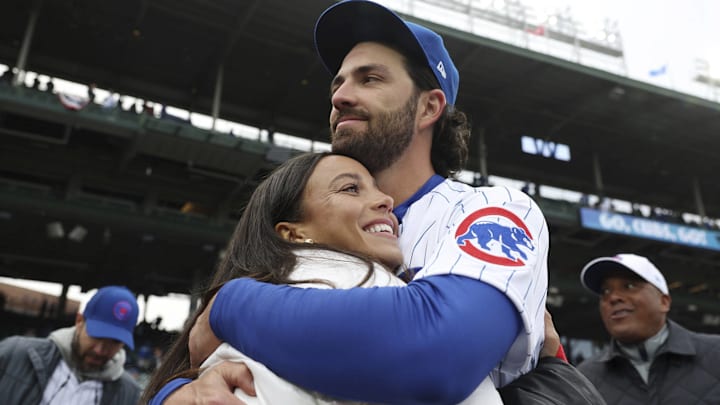 Chicago Cubs shortstop Dansby Swanson hugs his wife, Chicago Stars forward Mallory Swanson, on opening day at Wrigley Field on March 30, 2023, in Chicago.