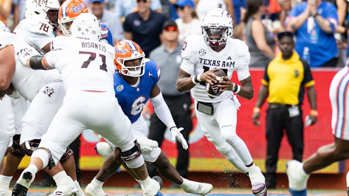 Sep 14, 2024; Gainesville, Florida, USA; Texas A&M Aggies quarterback Marcel Reed (10) scrambles with the ball past Florida Gators linebacker Shemar James (6) during the first half at Ben Hill Griffin Stadium. Mandatory Credit: Matt Pendleton-Imagn Images
