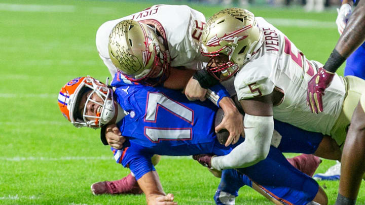 Florida Gators quarterback Max Brown (17) gets stopped by Florida State Seminoles defensive lineman Jared Verse (5) and Florida State Seminoles defensive lineman Braden Fiske (55) during first half action as Florida takes on Florida State at Steve Spurrier Field at Ben Hill Griffin Stadium in Gainesville, FL on Saturday, November 25, 2023. [Alan Youngblood/Gainesville Sun]