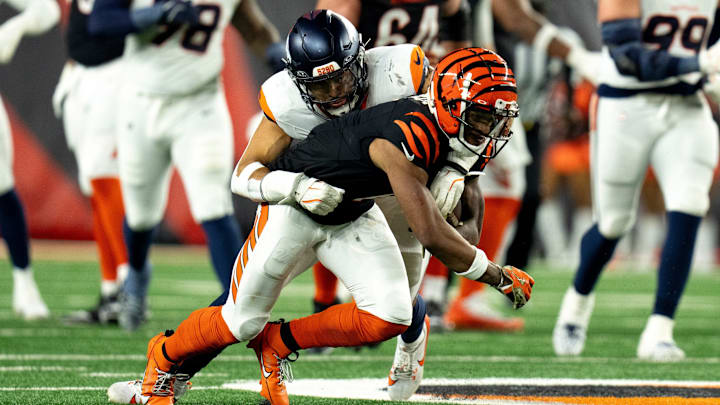 Denver Broncos inside linebacker Justin Strnad (40) tackles Cincinnati Bengals wide receiver Ja'Marr Chase (1) in the third quarter of the NFL game at Paycor Stadium in Cincinnati on Saturday, Dec. 28, 2024. Denver Broncos inside linebacker Justin Strnad (40) tackles Cincinnati Bengals wide receiver Ja'Marr Chase (1) in the third quarter of the NFL game at Paycor Stadium in Cincinnati on Saturday, Dec. 28, 2024.