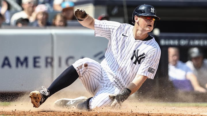 Aug 25, 2024; Bronx, New York, USA;  New York Yankees first baseman DJ LeMahieu (26) slides safely at home plate in the second inning against the Colorado Rockies at Yankee Stadium. Mandatory Credit: Wendell Cruz-Imagn Images