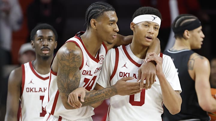 Feb 22, 2025; Norman, Oklahoma, USA; Oklahoma Sooners forward Jalon Moore and guard Jeremiah Fears react after a play against the Mississippi State Bulldogs.