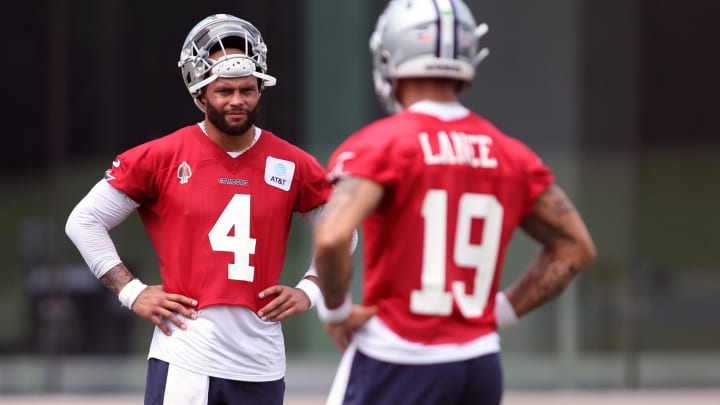 Jun 4, 2024; Frisco, TX, USA; Dallas Cowboys quarterback Dak Prescott (4) and quarterback Trey Lance (19) stand on the field during practice at the Ford Center at the Star Training Facility in Frisco, Texas.