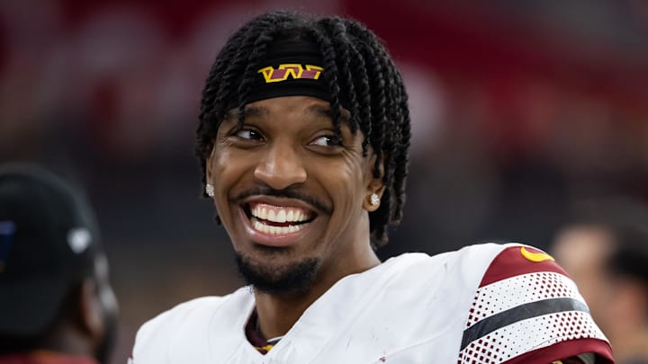 Sep 29, 2024; Glendale, Arizona, USA; Washington Commanders quarterback Jayden Daniels (5) against the Arizona Cardinals at State Farm Stadium. Mandatory Credit: Mark J. Rebilas-Imagn Images