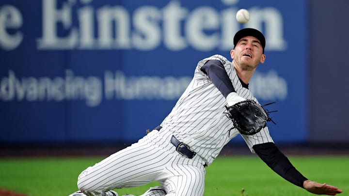 Oct 8, 2025; Bronx, New York, USA; New York Yankees left fielder Cody Bellinger (35) slides to makes a catch during the first inning against the Toronto Blue Jays during game four of the ALDS round for the 2025 MLB playoffs at Yankee Stadium. Mandatory Credit: Brad Penner-Imagn Images