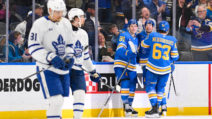 Mar 28, 2026; St. Louis, Missouri, USA; St. Louis Blues left wing Dylan Holloway (81) is congratulated by right wing Jordan Kyrou (25) and left wing Jake Neighbours (63) after scoring against the Toronto Maple Leafs during the third period at Enterprise Center. Mandatory Credit: Jeff Curry-Imagn Images