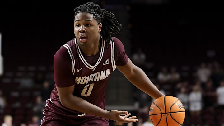 Nov 18, 2025; College Station, Texas, USA; Montana Grizzlies guard Money Williams (0) looks to pass the ball during the second half against the Texas A&M Aggies at Reed Arena. Mandatory Credit: Maria Lysaker-Imagn Images 