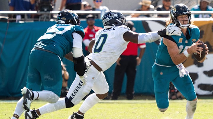 Seattle Seahawks DeMarcus Lawrence (0) gets a hand one Jacksonville Jaguars quarterback Trevor Lawrence (16) during the third quarter in an NFL football game at EverBank Stadium, Sunday, Oct. 12, 2025, in Jacksonville, Fla. [Doug Engle/Florida Times-Union]