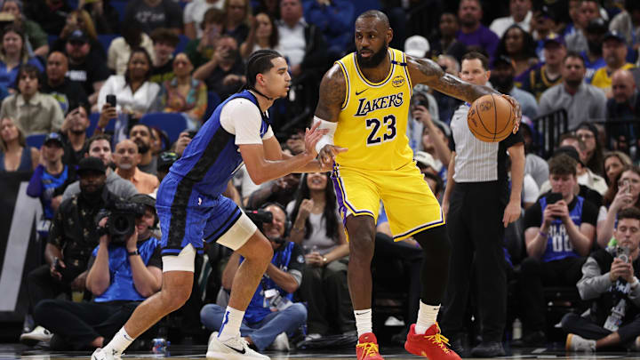 Mar 24, 2025; Orlando, Florida, USA; Los Angeles Lakers forward LeBron James (23) is guarded by Orlando Magic guard Anthony Black (0) in the fourth quarter at Kia Center. Mandatory Credit: Nathan Ray Seebeck-Imagn Images