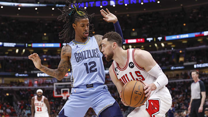 Apr 2, 2023; Chicago, Illinois, USA; Memphis Grizzlies guard Ja Morant (12) defends against Chicago Bulls guard Zach LaVine (8) during the second half at United Center. Mandatory Credit: Kamil Krzaczynski-Imagn Images