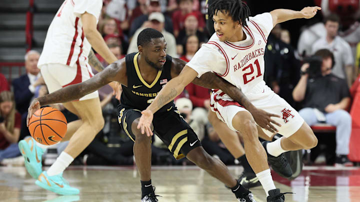 Jan 20, 2026; Fayetteville, Arkansas, USA; Vanderbilt Commodores guard Duke Miles (2) drives against Arkansas Razorbacks guard D.J. Wagner (21) during the first half at Bud Walton Arena. Mandatory Credit: Nelson Chenault-Imagn Images
