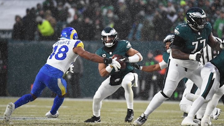 Jan 19, 2025; Philadelphia, Pennsylvania, USA; Philadelphia Eagles quarterback Jalen Hurts (1) prepares to throw the ball as Los Angeles Rams linebacker Omar Speights (48) defends in the first half in a 2025 NFC divisional round game at Lincoln Financial Field. Mandatory Credit: Eric Hartline-Imagn Images