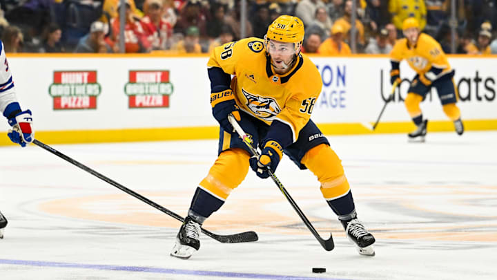 Dec 21, 2025; Nashville, Tennessee, USA;  Nashville Predators left wing Michael Bunting (58) skates with the puck against the New York Rangers during the third period at Bridgestone Arena. Mandatory Credit: Steve Roberts-Imagn Images