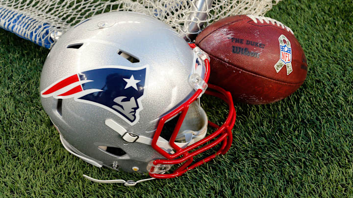 Dec 14, 2014; Foxborough, MA, USA; A New England Patriots helmet and an NFL football are seen on the sidelines during the second half of the New England Patriots 41-13 win over the Miami Dolphins at Gillette Stadium. Mandatory Credit: Winslow Townson-Imagn Images