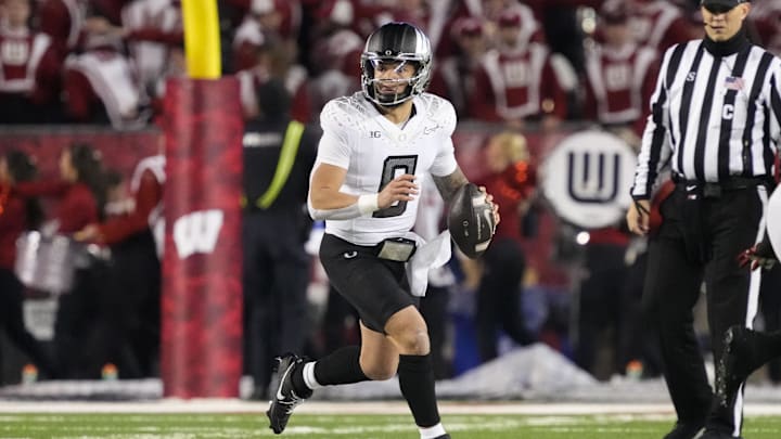 Nov 16, 2024; Madison, Wisconsin, USA;  Oregon Ducks quarterback Dillon Gabriel (8) looks to throw a pass during the third quarter against the Wisconsin Badgers at Camp Randall Stadium. Mandatory Credit: Jeff Hanisch-Imagn Images