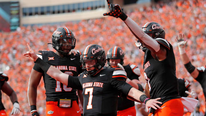 Oklahoma State's Alan Bowman (7) celebrates his touchdown with Ollie Gordon II (0) and Rashod Owens (10) in the first half during a Bedlam college football game between the Oklahoma State University Cowboys (OSU) and the University of Oklahoma Sooners (OU) at Boone Pickens Stadium in Stillwater, Okla., Saturday, Nov. 4, 2023.