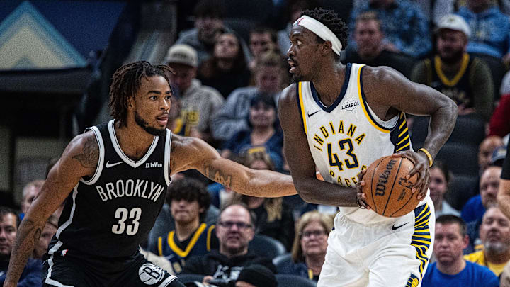 Nov 5, 2025; Indianapolis, Indiana, USA; Indiana Pacers forward Pascal Siakam (43) holds the ball while Brooklyn Nets center Nic Claxton (33) defends in the second half  at Gainbridge Fieldhouse. Mandatory Credit: Trevor Ruszkowski-Imagn Images