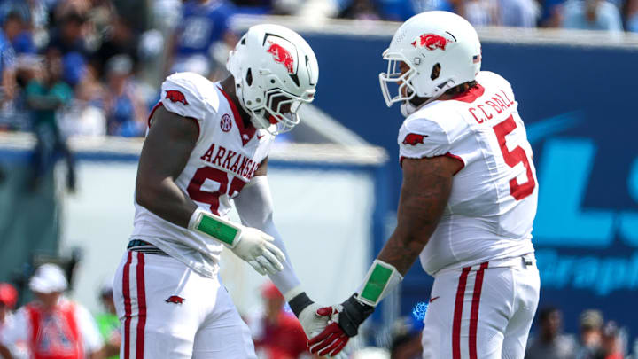 Sep 20, 2025; Memphis, Tennessee, USA; Arkansas Razorbacks defensive linemen Quincy Rhodes Jr. (97) and Cameron Ball (5) celebrate a stop against the Memphis Tigers during the second half at Simmons Bank Liberty Stadium. Mandatory Credit: Wesley Hale-Imagn Images