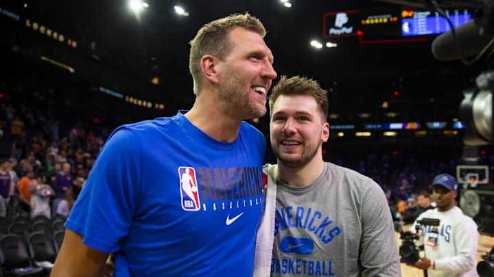 May 15, 2022; Phoenix, Arizona, USA; Dallas Mavericks guard Luka Doncic (right) with former player Dirk Nowitzki against the Phoenix Suns in game seven of the second round for the 2022 NBA playoffs at Footprint Center. Mandatory Credit: Mark J. Rebilas-Imagn Images