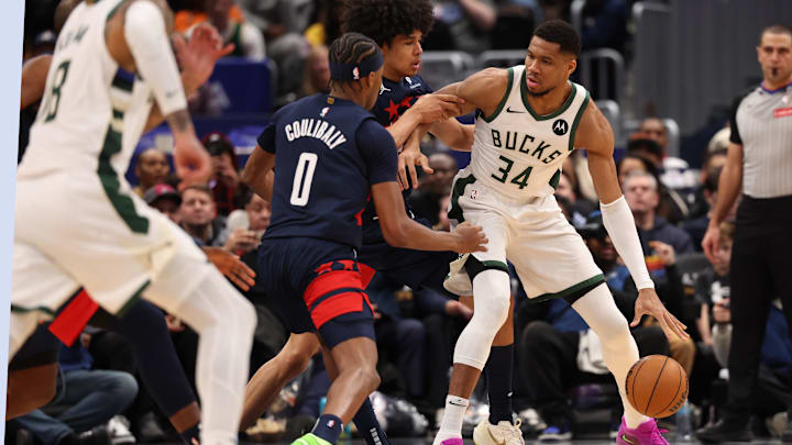 Feb 21, 2025; Washington, District of Columbia, USA; Milwaukee Bucks forward Giannis Antetokounmpo (34) dribbles the ball as Washington Wizards forward Kyshawn George (18) and Wizards guard Bilal Coulibaly (0) defend in the second half at Capital One Arena. Mandatory Credit: Geoff Burke-Imagn Images