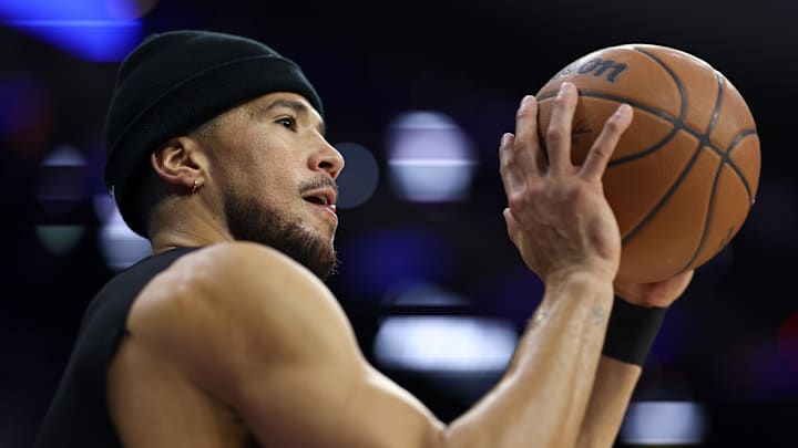 Jan 20, 2026; Philadelphia, Pennsylvania, USA; Phoenix Suns guard Devin Booker warms up before a game against the Philadelphia 76ers at Xfinity Mobile Arena. Mandatory Credit: Bill Streicher-Imagn Images