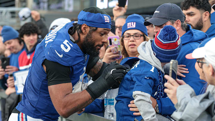 Dec 29, 2024; East Rutherford, New Jersey, USA; New York Giants linebacker Kayvon Thibodeaux (5) signs an autograph after the game against the Indianapolis Colts at MetLife Stadium. Mandatory Credit: Vincent Carchietta-Imagn Images