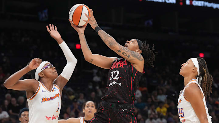 Jun 29, 2022; Phoenix, Arizona, USA; Indiana Fever forward Emma Cannon (32) shoots a layup over Phoenix Mercury guard Diamond DeShields (1) during the second half at Footprint Center. Mandatory Credit: Joe Camporeale-Imagn Images