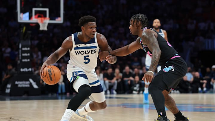 Jan 3, 2026; Miami, Florida, USA; Minnesota Timberwolves guard Anthony Edwards (5) drives to the basket against Miami Heat guard Davion Mitchell (45) during the first quarter at Kaseya Center. Mandatory Credit: Sam Navarro-Imagn Images