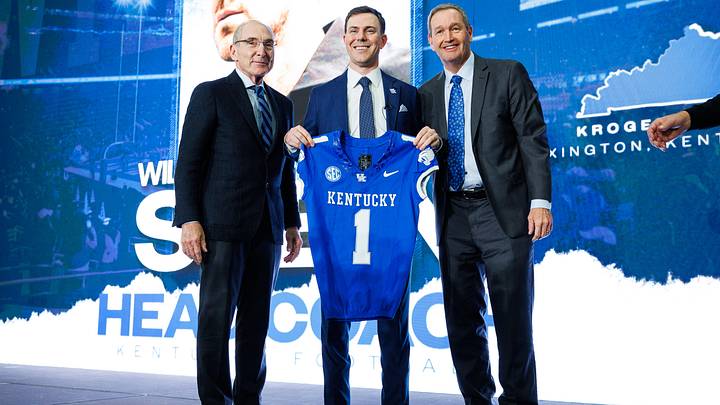 Dec 3, 2025; Lexington, KY, USA; Kentucky Wildcats head football coach Will Stein poses for a photo with University of Kentucky President Dr. Eli Capilouto (left) and athletic director Mitch Barnhart (right) after his press conference at Nutter Field House. Mandatory Credit: Jordan Prather-Imagn Images