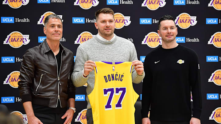 Feb 4, 2025; El Segundo, CA, USA; Los Angeles Lakers guard Luka Doncic poses for photos with general manager Rob Pelinka and head coach JJ Redick at UCLA Health Training Center. Mandatory Credit: Gary A. Vasquez-Imagn Images