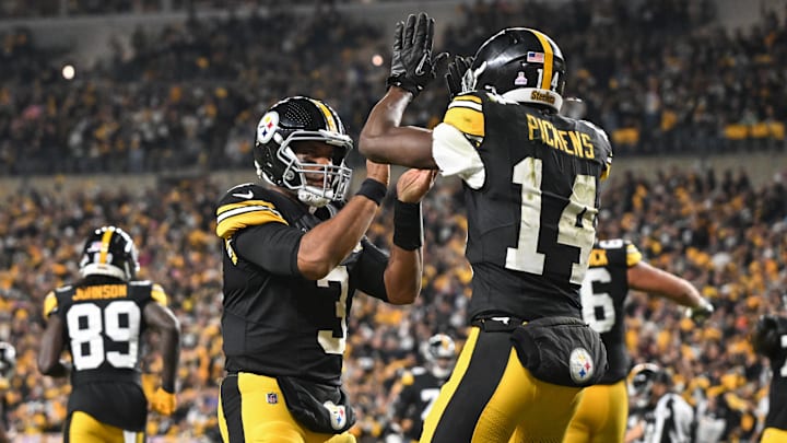 Oct 20, 2024; Pittsburgh, Pennsylvania, USA; Pittsburgh Steelers wide receiver George Pickens (14) celebrates an 11 yard touchdown pass with quarterback Russell Wilson (3) iagainst the New York Jets during the second quarter at Acrisure Stadium. Mandatory Credit: Barry Reeger-Imagn Images